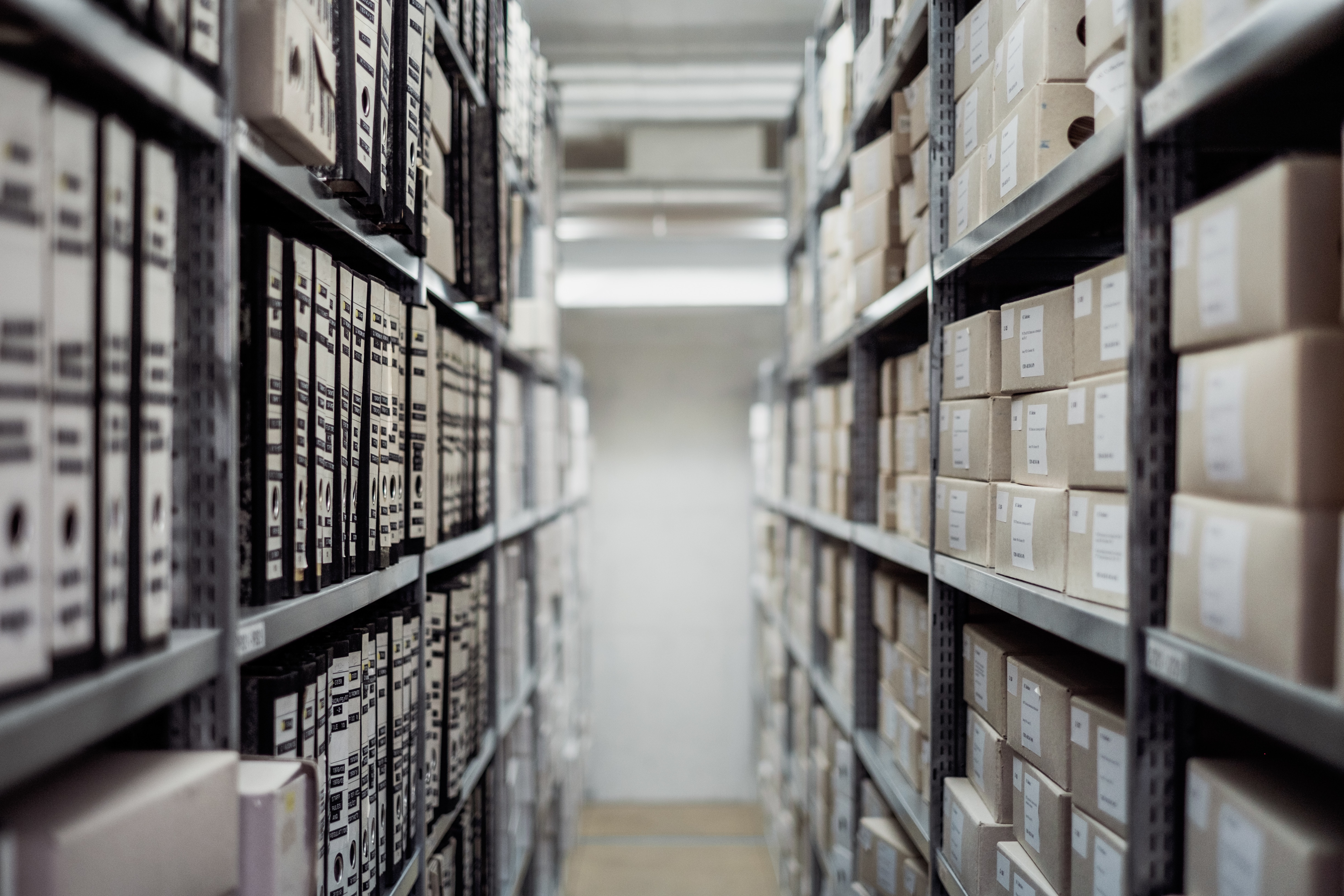 Organized archive shelves filled with document folders and boxes